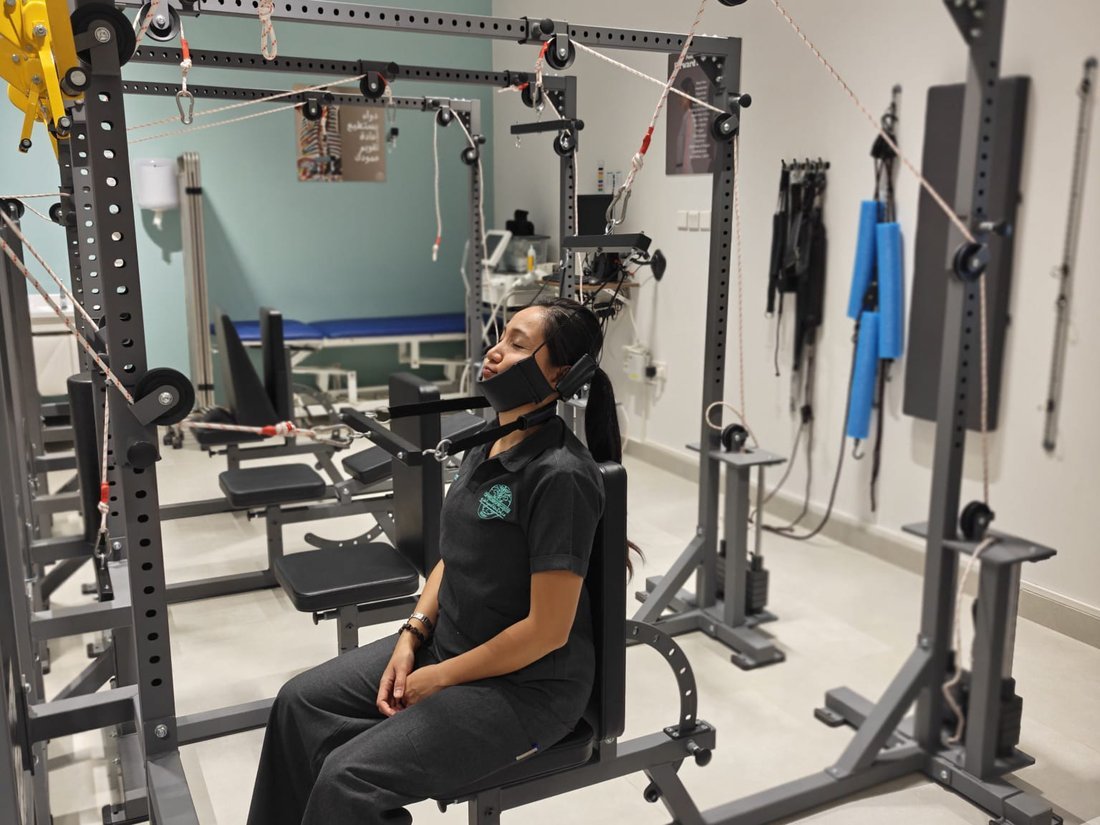 Patient receiving corrective cervical spinal traction in the rehabilitation studio