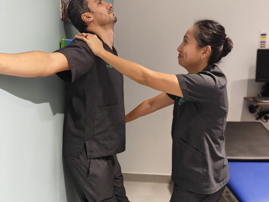 Posture-focused rehabilitation exercise guided by a clinician in Muscat