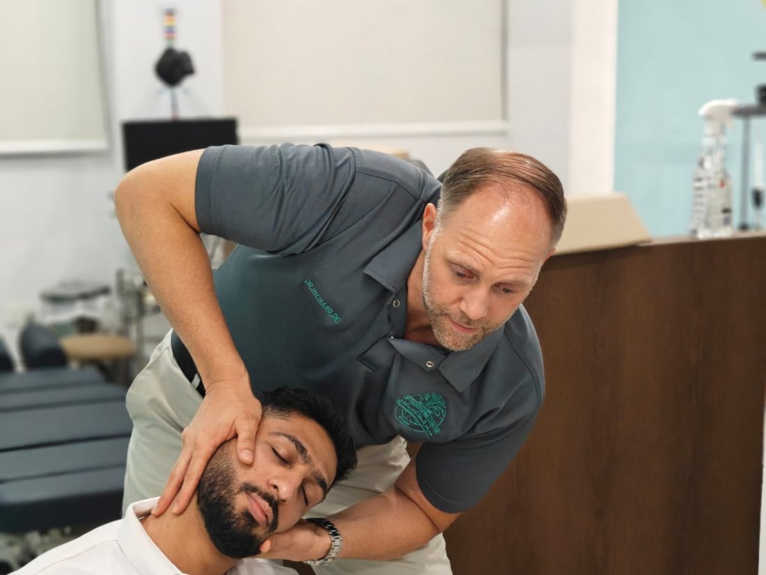 Dr Richard performing a gentle cervical chiropractic adjustment