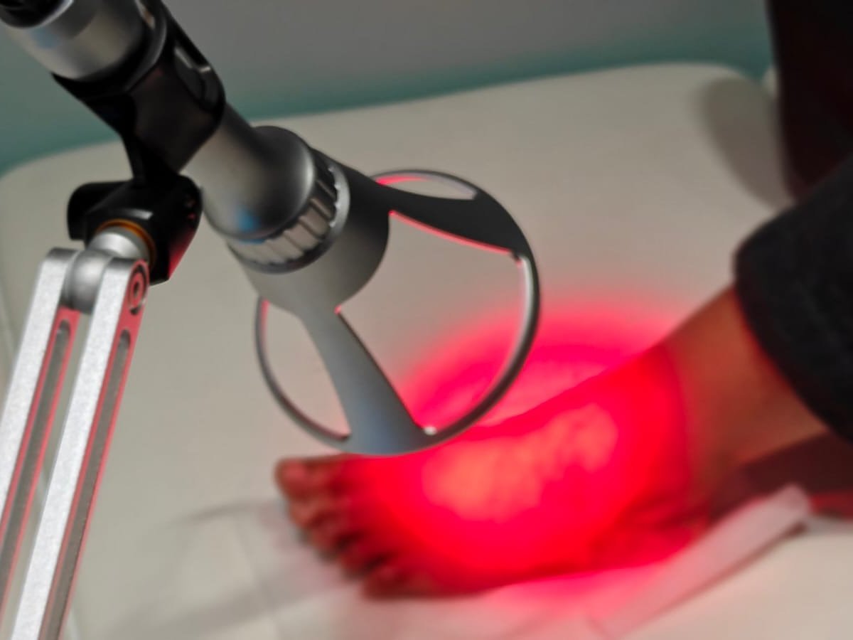 Class 4 laser therapy directed at the foot during treatment at CBP Precision Spine Center